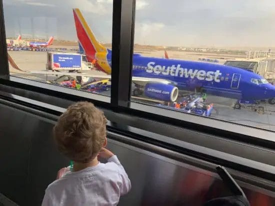 Child looking out airport window best and worst airlines southwest\